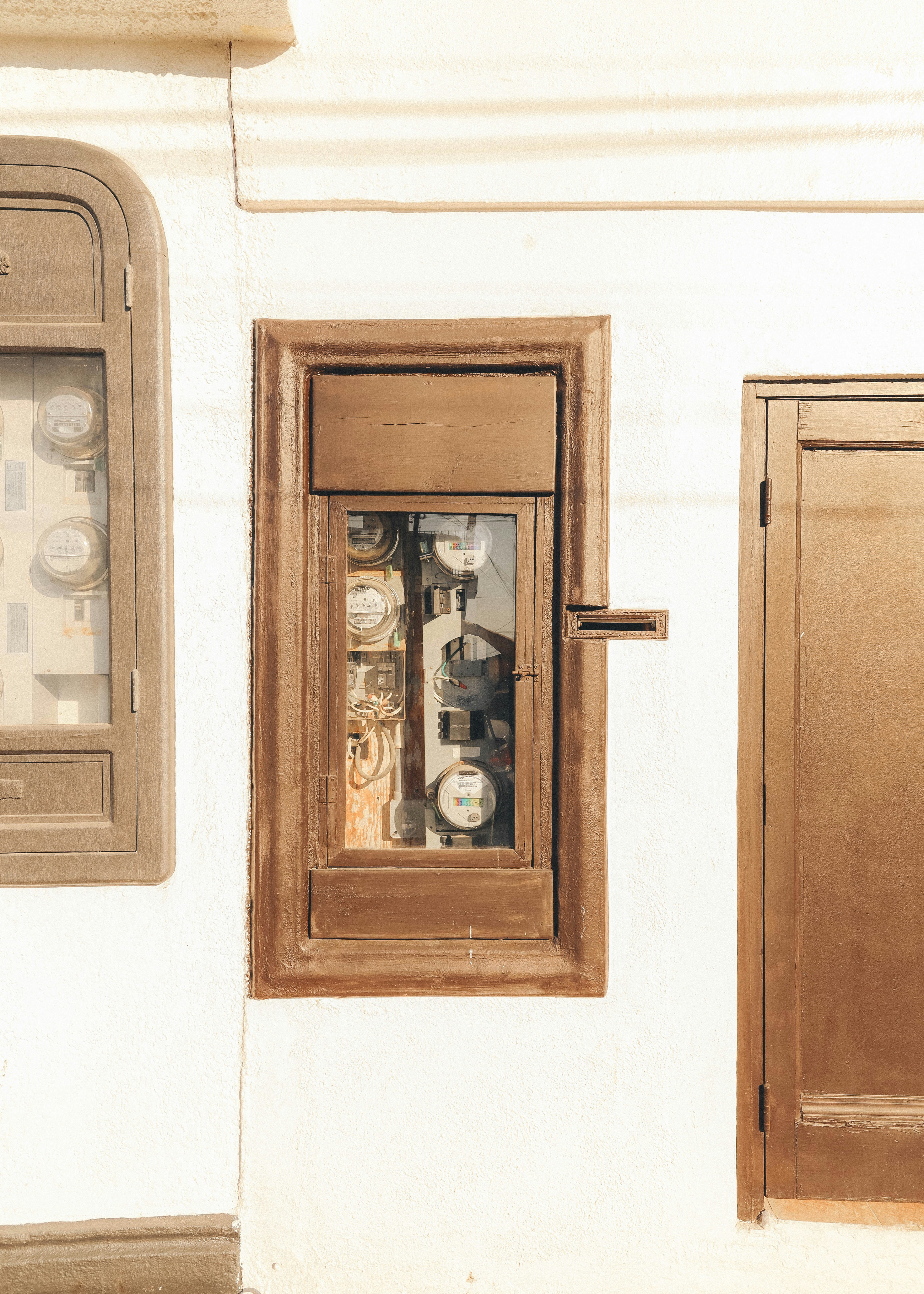 brown wooden door with white wall